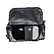 A large black duffel bag open with contents inside against a white background