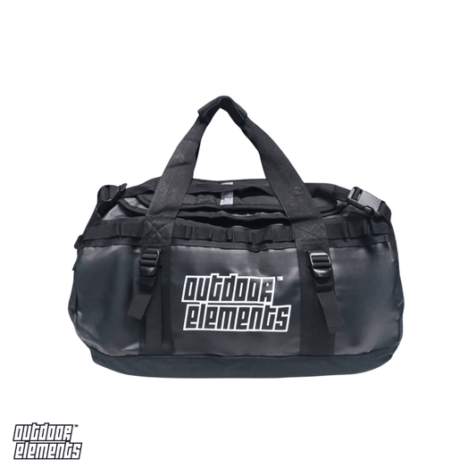 A black Outdoor Elements duffel bag with dual top handles, multiple compression straps, against a plain white background.