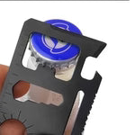 "Stainless steel survival card showing can opener knife screwdriver and wrench tools"